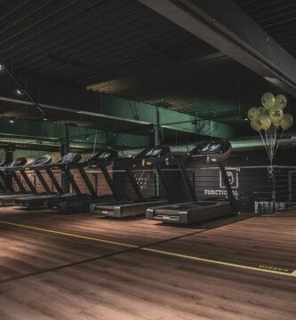 dark moody gym with treadmills