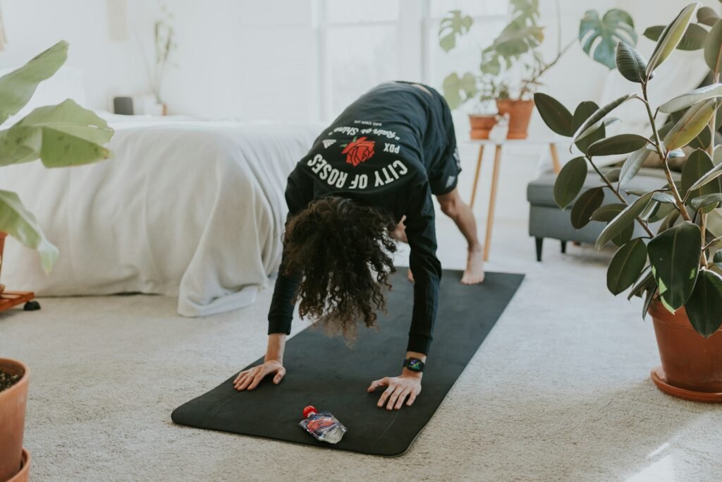 woman is doing a yoga pose on a mat