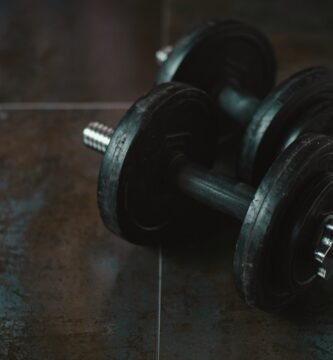 pair of black dumbbells on a floor